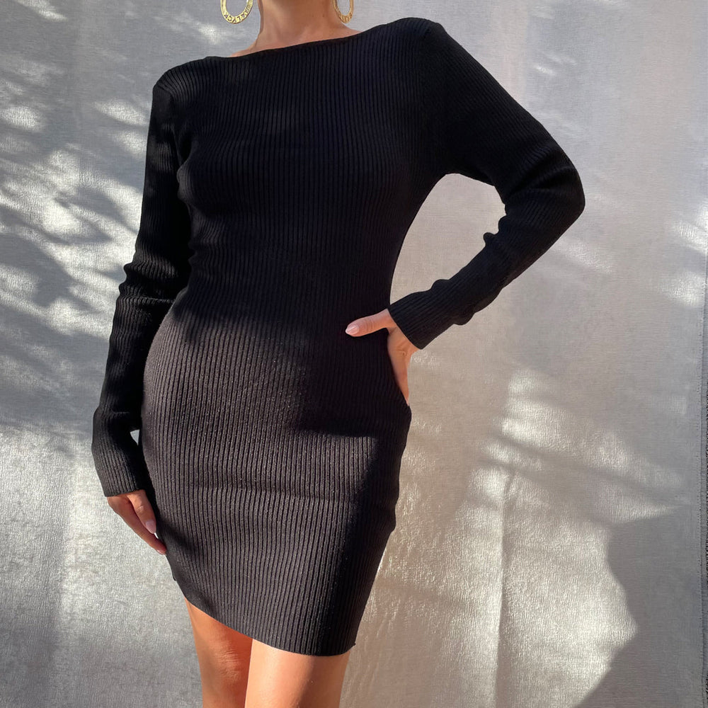 Female model wearing black long sleeve knit mini dress