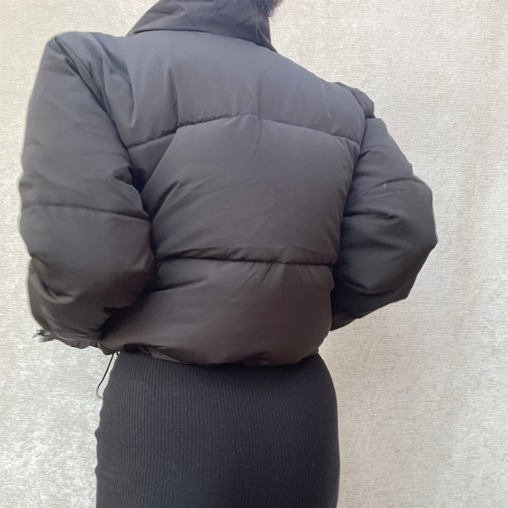 Female model wearing black cropped puffer jacket